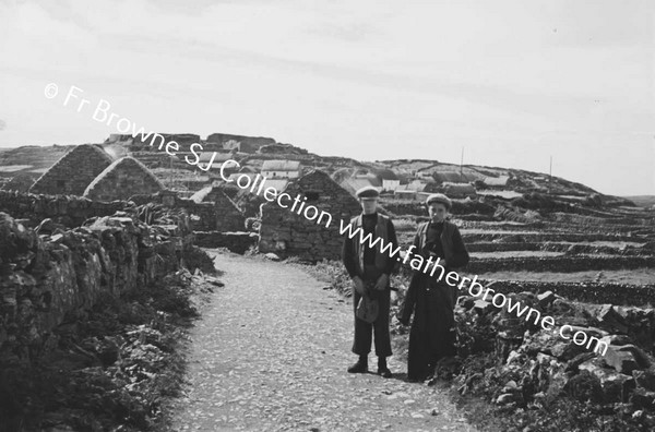 MEN ON ROAD NEAR VILLAGE